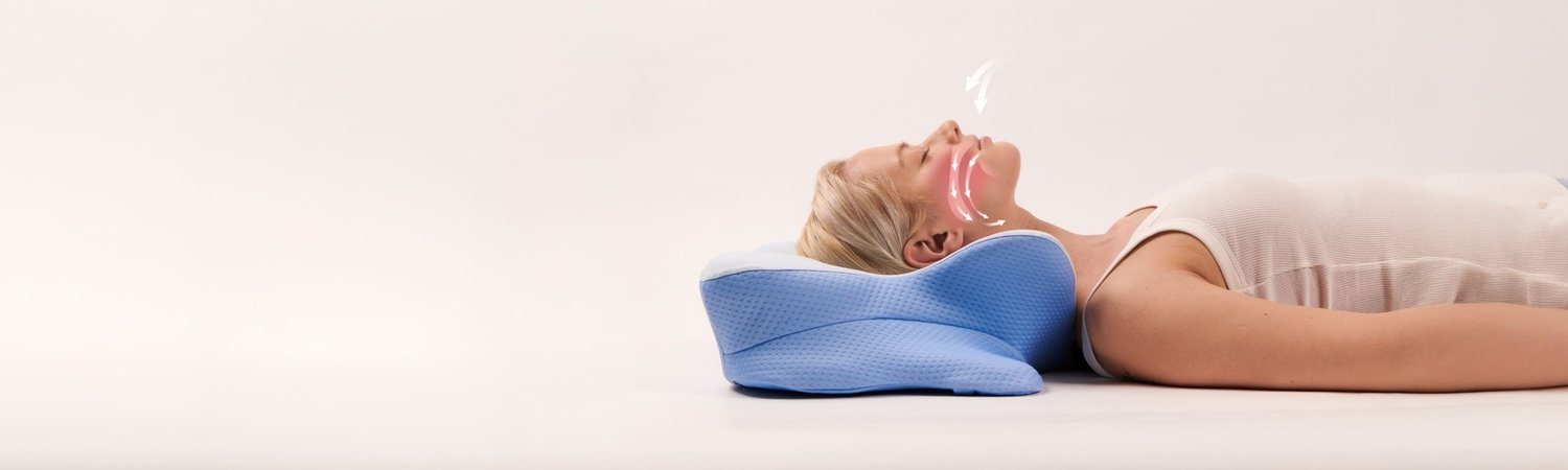 A woman lying on her back, her head resting in the Derila Ergo pillow with her airway open and her neck supported.
